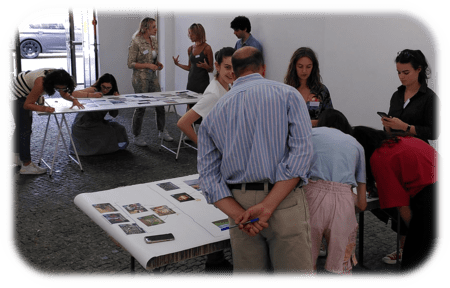 People having a look to cards on a table during a Climate Fresk workshop